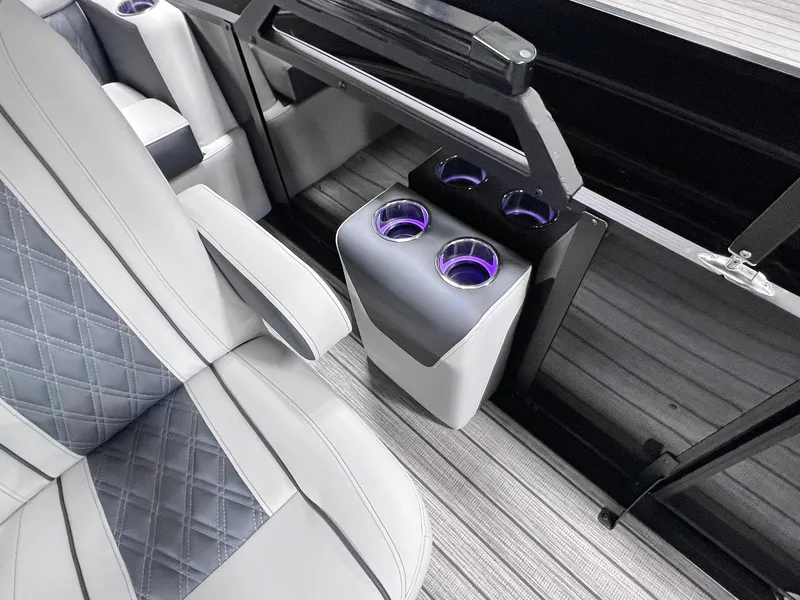 Slide: The Image of 2024 Harris Sunliner 250 interior with luxury seating and illuminated cup holders. - 30