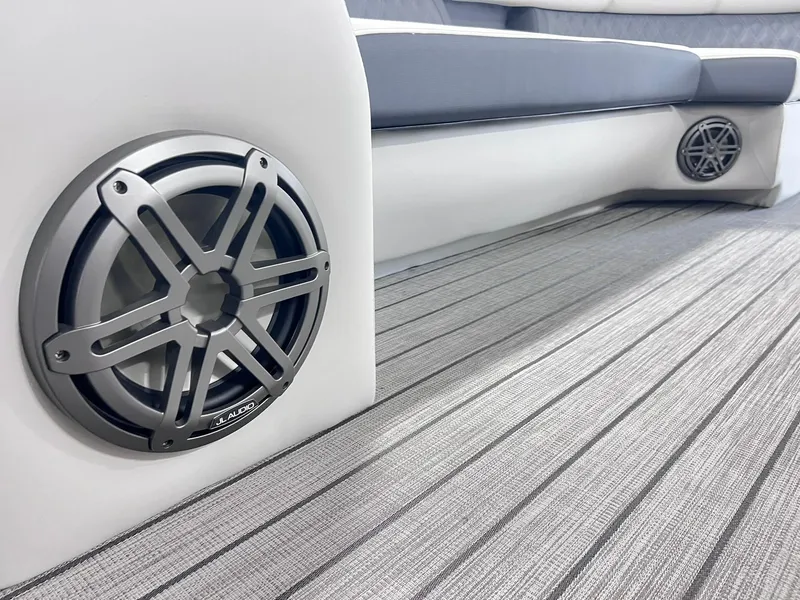 Slide: The Image of 2024 Harris Sunliner 250 boat interior with sleek speakers and modern seating. - 32