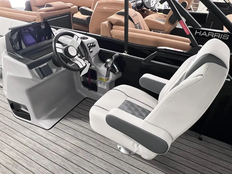Slide: The Image of 2024 Harris Sunliner 250 boat interior with modern helm and comfortable captain's chair. - 8