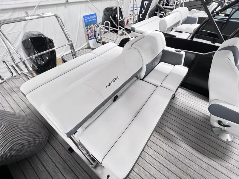 Slide: The Image of 2024 Harris Sunliner 250 boat interior with white seating and modern design. - 9
