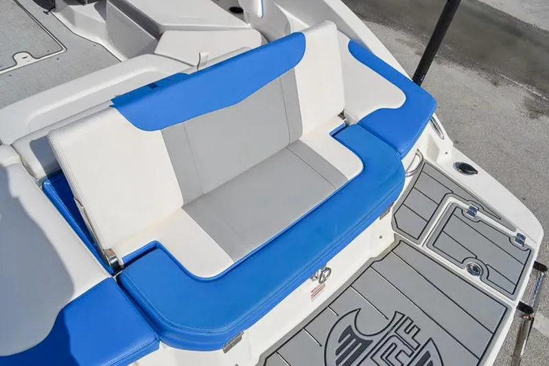 Slide: The Image of 2021 Chaparral 23 Surf boat with blue and white seating, rear deck view. - 12