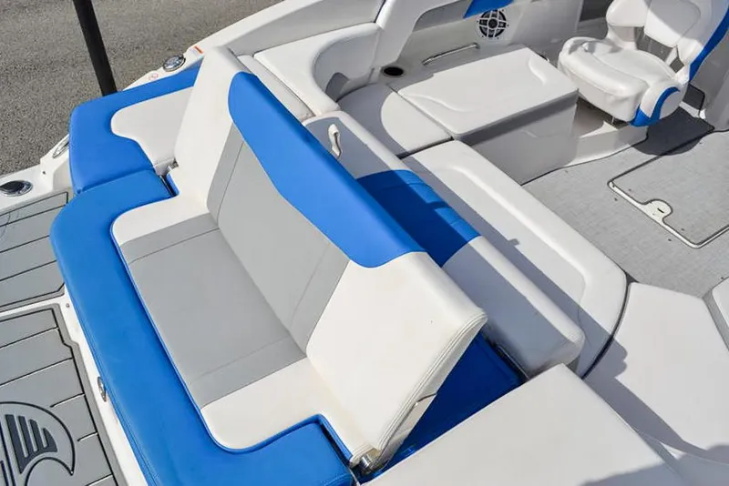 Slide: The Image of 2021 Chaparral 23 Surf boat interior with blue and white seating. - 13