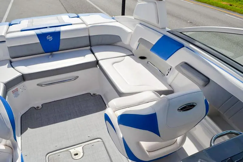 Slide: The Image of 2021 Chaparral 23 Surf boat interior with blue and white seating. - 16
