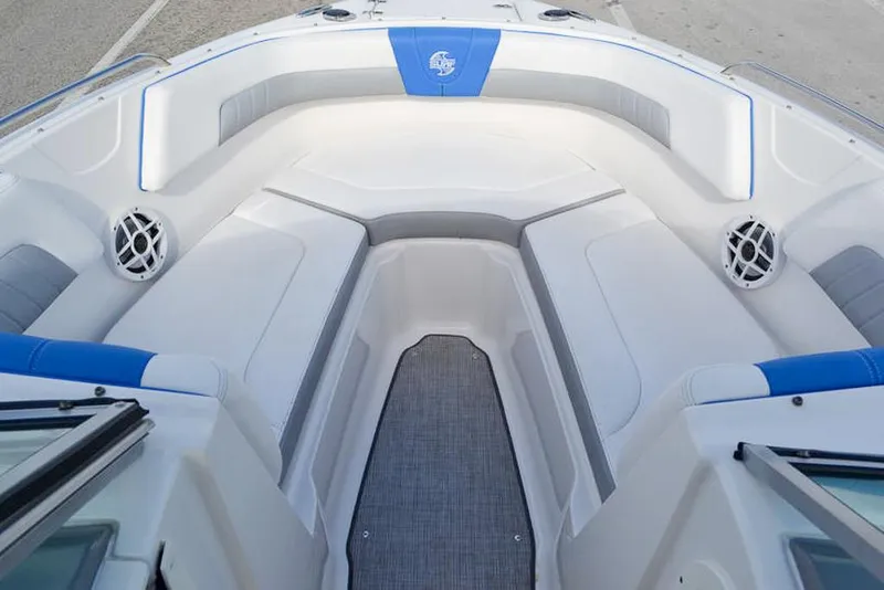 Slide: The Image of 2021 Chaparral 23 Surf boat interior with cushioned seating and speakers. - 18