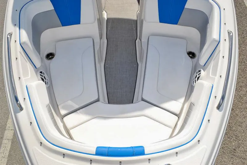 Slide: The Image of 2021 Chaparral 23 Surf boat interior with white and blue seating. - 19