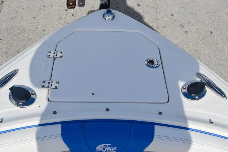 Slide: The Image of 2021 Chaparral 23 Surf boat bow with storage hatch and blue accents. - 20