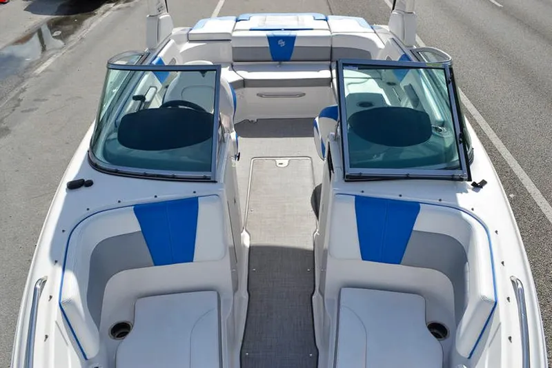Slide: The Image of 2021 Chaparral 23 Surf boat interior with blue and white seating. - 21