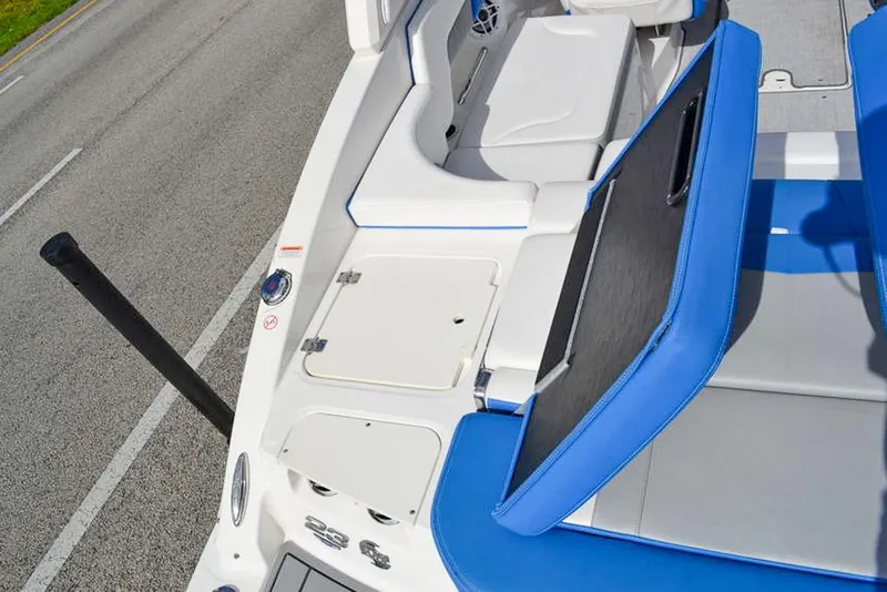 Slide: The Image of 2021 Chaparral 23 Surf boat interior with blue and white seating and storage compartments. - 30