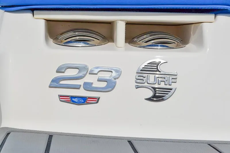 Slide: The Image of 2021 Chaparral 23 Surf boat emblem on white surface with blue accents. - 31