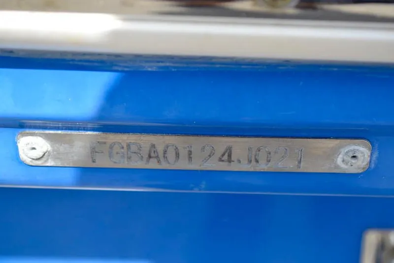 Slide: The Image of 2021 Chaparral 23 Surf boat identification plate on blue hull. - 37
