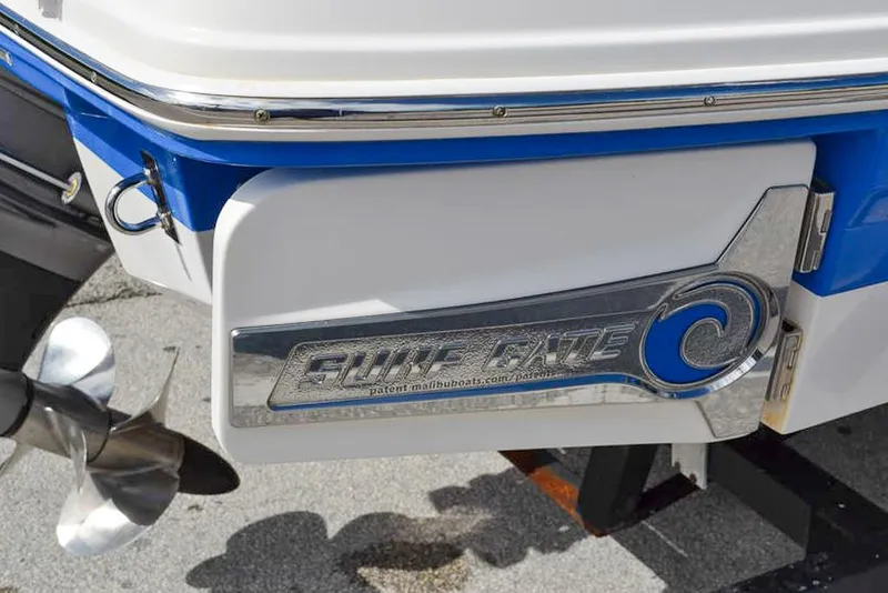 Slide: The Image of 2021 Chaparral 23 Surf boat with Surf Gate feature and propeller detail. - 7