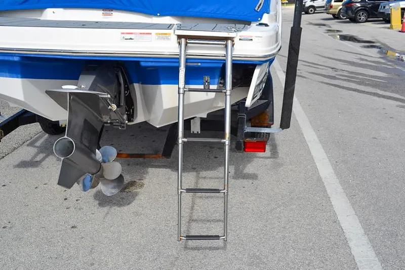 Slide: The Image of 2021 Chaparral 23 Surf boat rear view with ladder and propeller. - 8