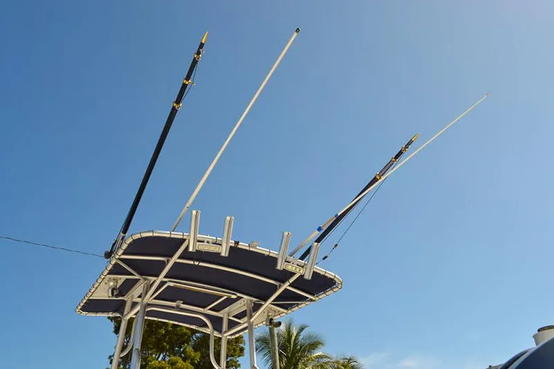 Slide: The Image of Fishing rods on Clearwater 2500 WI CC boat, 2006 model, against clear blue sky. - 15