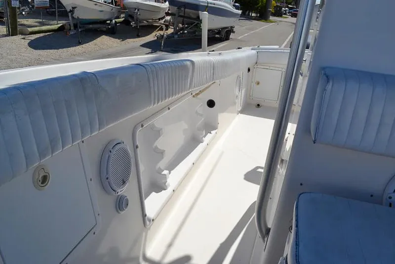 Slide: The Image of 2006 Clearwater 2500 WI CC boat interior with cushioned seating and storage compartments. - 19