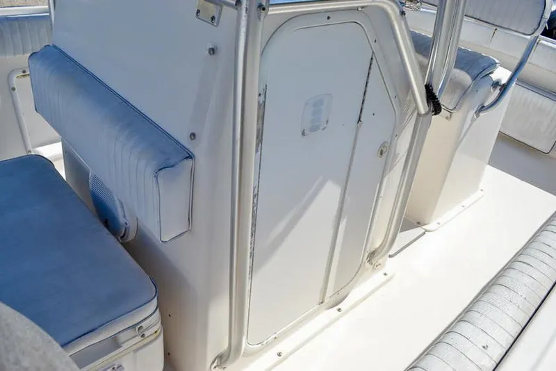 Slide: The Image of 2006 Clearwater 2500 WI CC boat interior with cushioned seating and storage. - 21