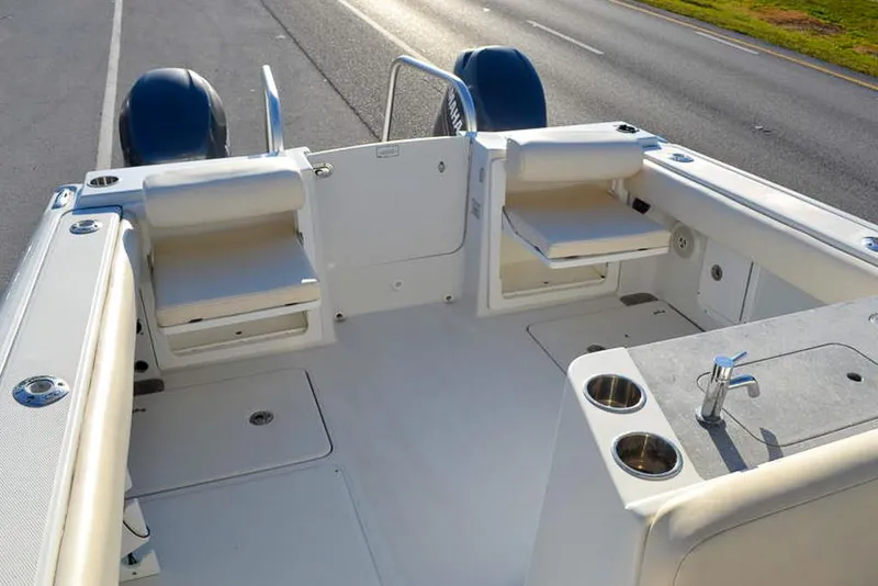Slide: The Image of 2011 Glacier Bay 2740 Dual Console boat interior with seating and cup holders. - 12