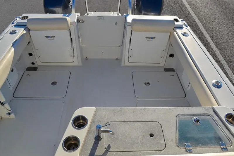 Slide: The Image of 2011 Glacier Bay 2740 Dual Console boat interior with storage and seating. - 13