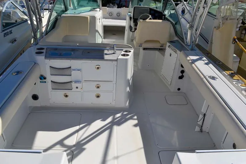Slide: The Image of 2011 Glacier Bay 2740 Dual Console boat interior with seating and storage compartments. - 14