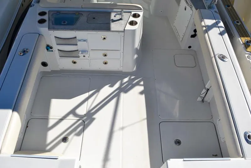 Slide: The Image of 2011 Glacier Bay 2740 Dual Console boat interior with storage and seating. - 15