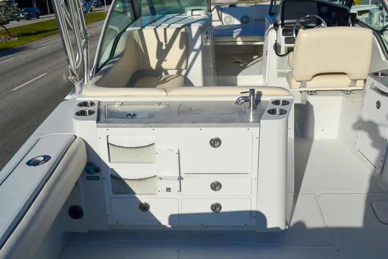 Slide: The Image of 2011 Glacier Bay 2740 Dual Console boat interior with seating and storage compartments. - 16