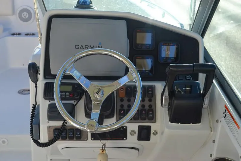 Slide: The Image of Control panel of 2011 Glacier Bay 2740 Dual Console boat with Garmin navigation system. - 18