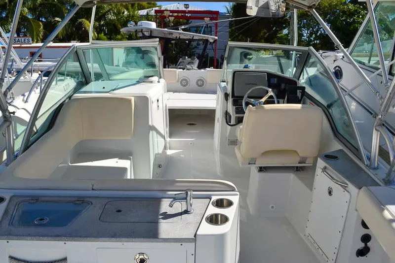 Slide: The Image of 2011 Glacier Bay 2740 Dual Console boat interior with seating and helm. - 19