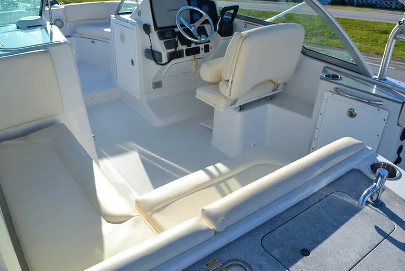 Slide: The Image of 2011 Glacier Bay 2740 Dual Console boat interior with white seating and steering console. - 20
