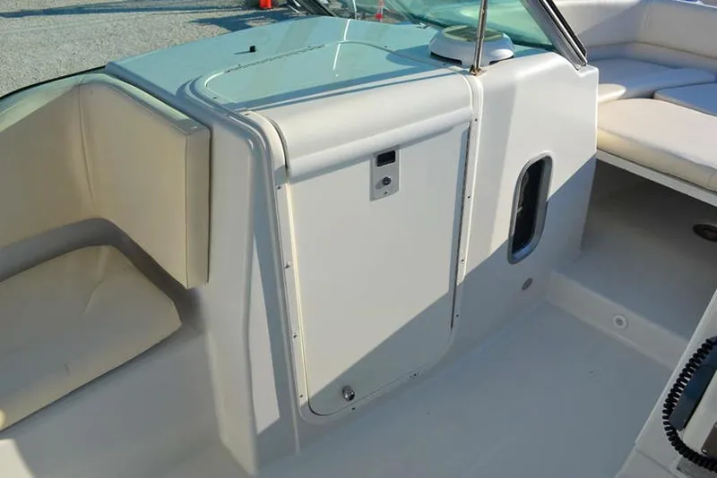 Slide: The Image of 2011 Glacier Bay 2740 Dual Console interior with seating and storage compartment. - 22