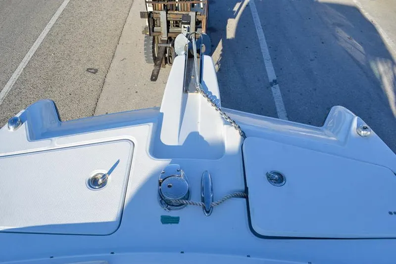 Slide: The Image of 2011 Glacier Bay 2740 Dual Console boat deck with anchor chain and storage compartments. - 28