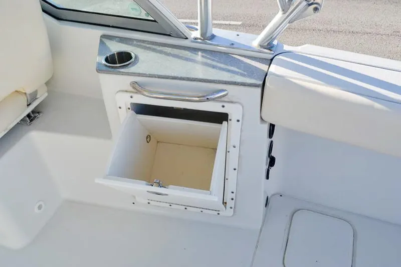 Slide: The Image of 2011 Glacier Bay 2740 Dual Console boat interior with open storage compartment. - 29