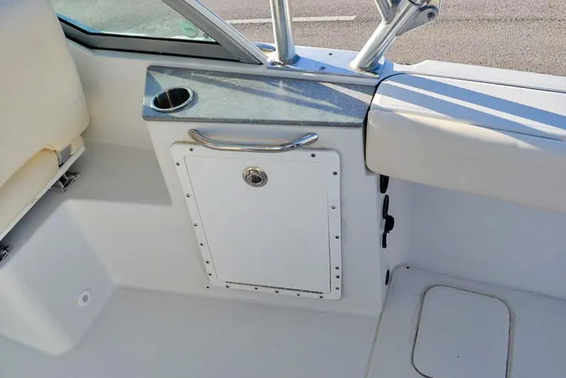 Slide: The Image of Interior of 2011 Glacier Bay 2740 Dual Console boat, featuring seating and storage compartment. - 30