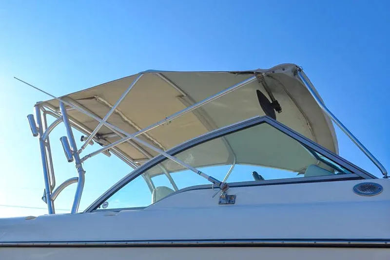 Slide: The Image of 2011 Glacier Bay 2740 Dual Console boat with canopy against clear blue sky. - 7