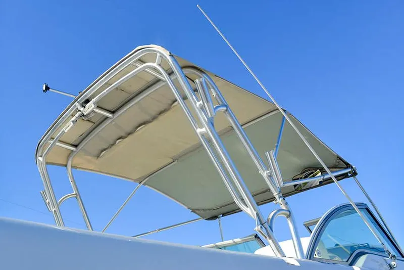 Slide: The Image of 2011 Glacier Bay 2740 Dual Console boat with canopy against clear blue sky. - 8