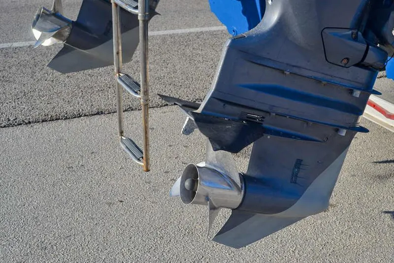 Slide: The Image of 2011 Glacier Bay 2740 Dual Console boat propellers and ladder on pavement. - 9
