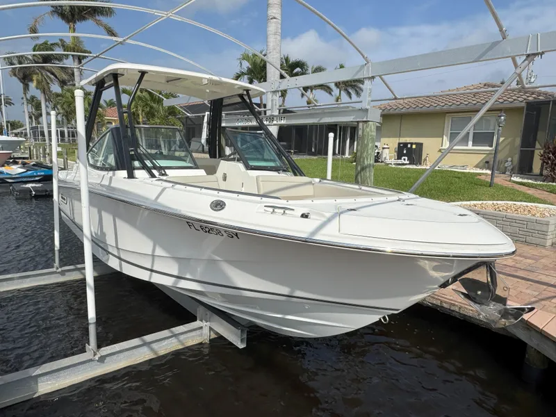 Slide: The Image of 2021 Boston Whaler 240 Vantage boat docked, featuring sleek design and spacious seating. - 2