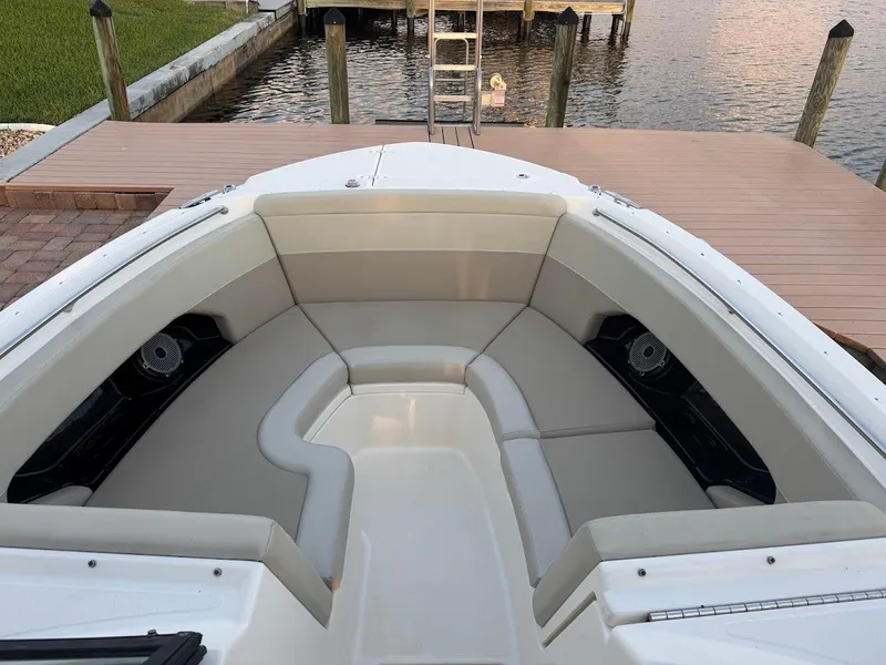 Slide: The Image of 2021 Boston Whaler 240 Vantage boat interior with cushioned seating at dock. - 23