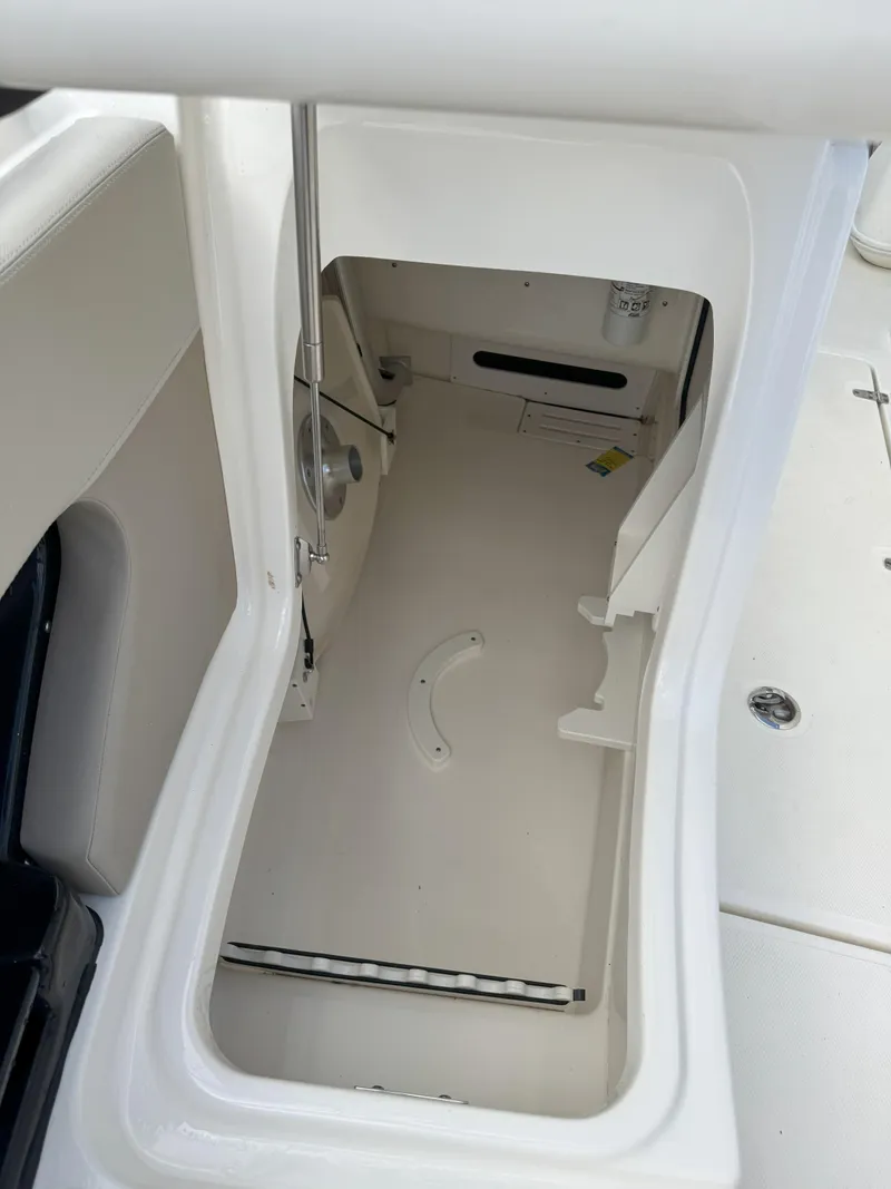 Slide: The Image of 2021 Boston Whaler 240 Vantage storage compartment, open and empty, showcasing interior space. - 25