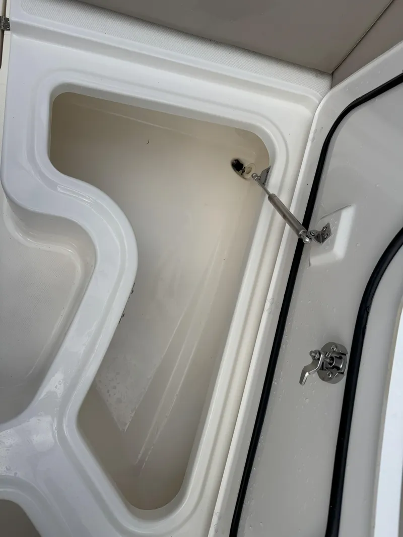 Slide: The Image of Storage compartment of 2021 Boston Whaler 240 Vantage boat, open and empty. - 26