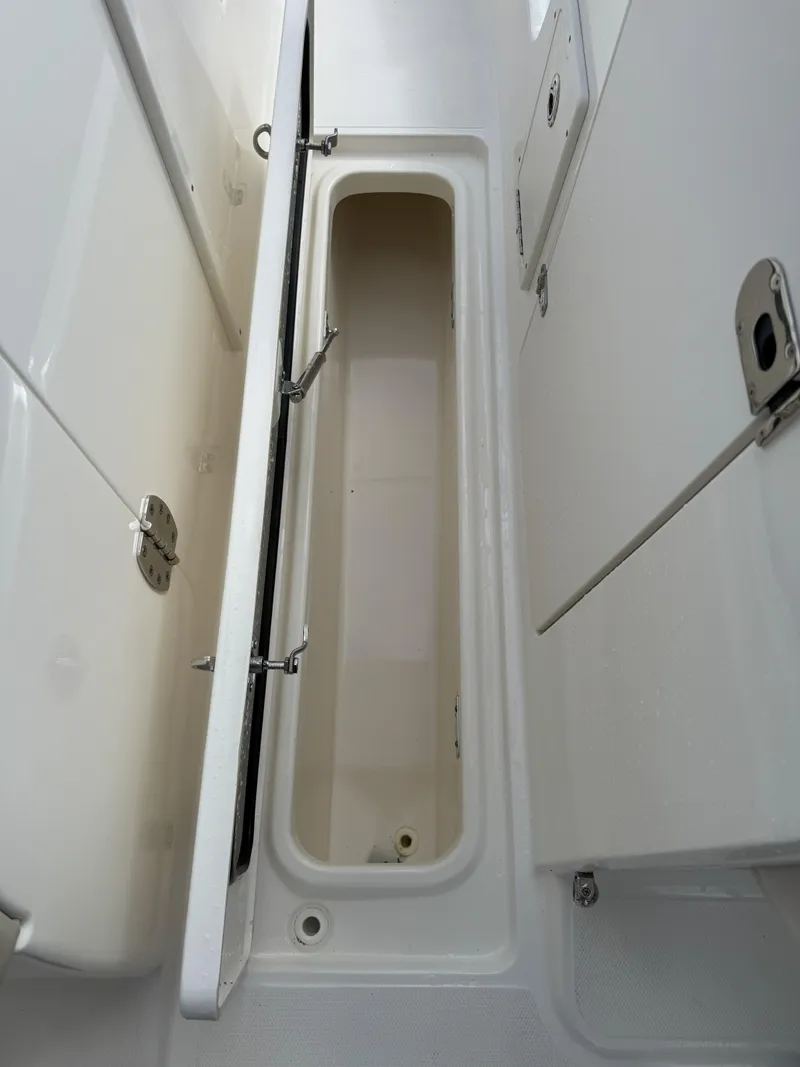 Slide: The Image of 2021 Boston Whaler 240 Vantage storage compartment, open and empty, showcasing interior space. - 29