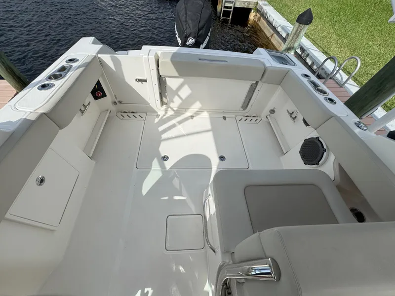 Slide: The Image of 2021 Boston Whaler 240 Vantage boat interior, featuring spacious seating and storage areas. - 32
