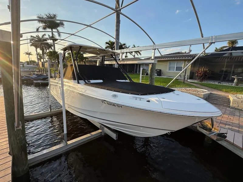 Slide: The Image of 2021 Boston Whaler 240 Vantage boat docked in a sunny marina setting. - 44