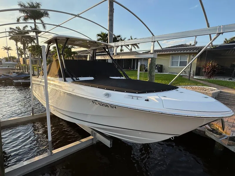 Slide: The Image of 2021 Boston Whaler 240 Vantage boat docked under a canopy in a residential area. - 47