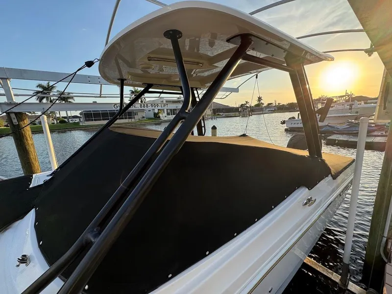 Slide: The Image of 2021 Boston Whaler 240 Vantage boat docked at sunset, featuring sleek design and covered deck. - 48