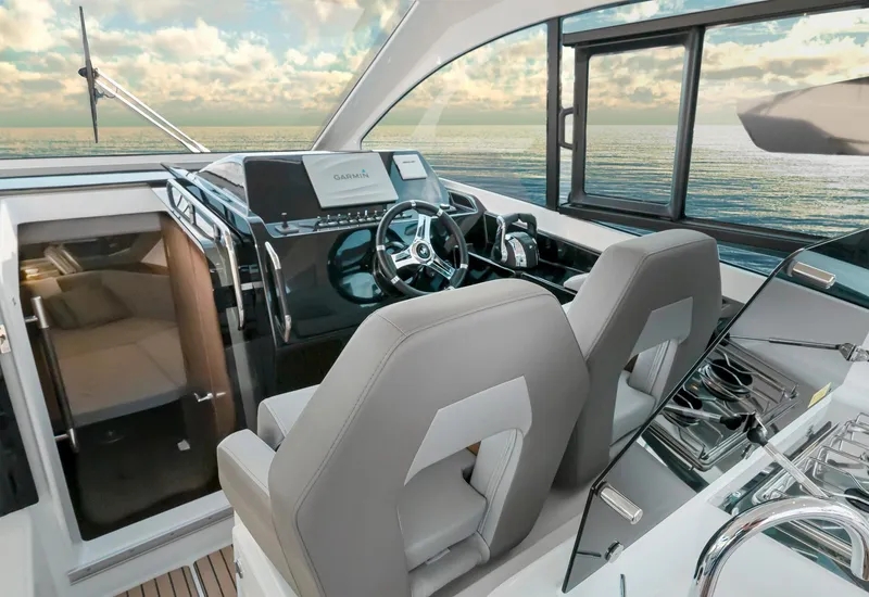 Slide: The Image of 2025 Beneteau 32 Gran Turismo yacht interior with modern helm and ocean view. - 11
