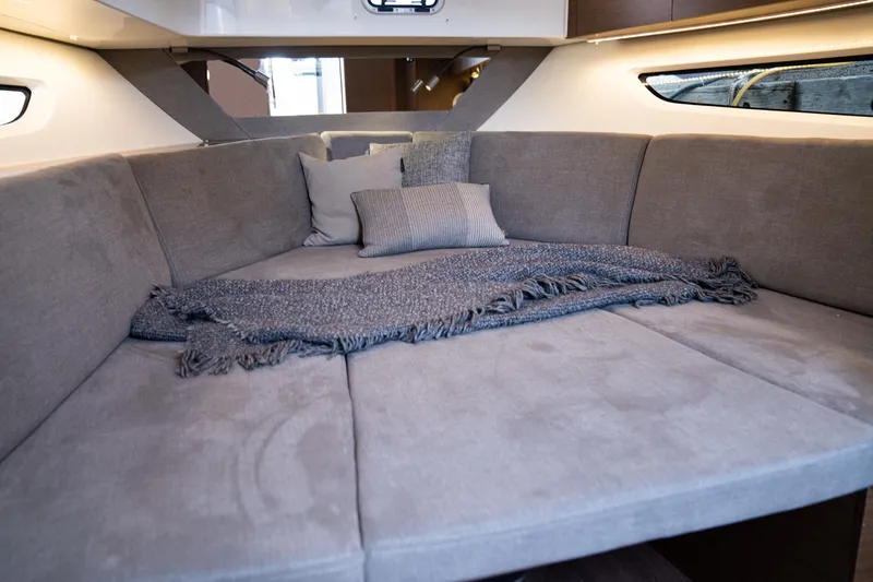 Slide: The Image of Interior cabin of 2025 Beneteau 32 Gran Turismo with cozy bedding and cushions. - 17