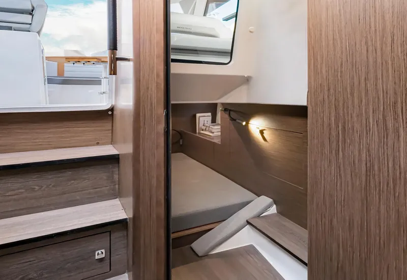 Slide: The Image of Interior cabin of 2025 Beneteau 32 Gran Turismo, featuring modern wood finish and cozy sleeping area. - 18