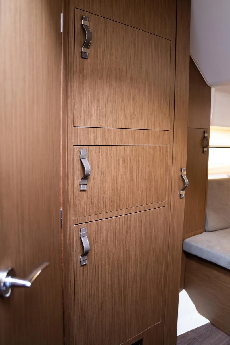 Slide: The Image of Interior of 2025 Beneteau 32 Gran Turismo yacht, featuring sleek wooden cabinetry and modern design. - 20