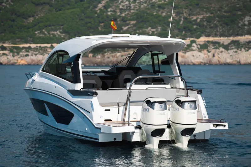 Slide: The Image of 2025 Beneteau 32 Gran Turismo boat with dual engines on a serene water backdrop. - 6