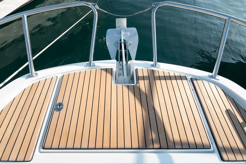 Slide: The Image of Beneteau 32 Gran Turismo 2025 boat deck with teak flooring and stainless steel railings. - 8