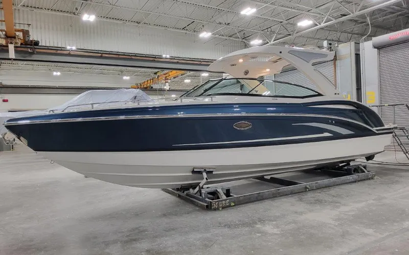 The Image of 2025 Formula 310 Bowrider I/O boat in a warehouse setting. - 1